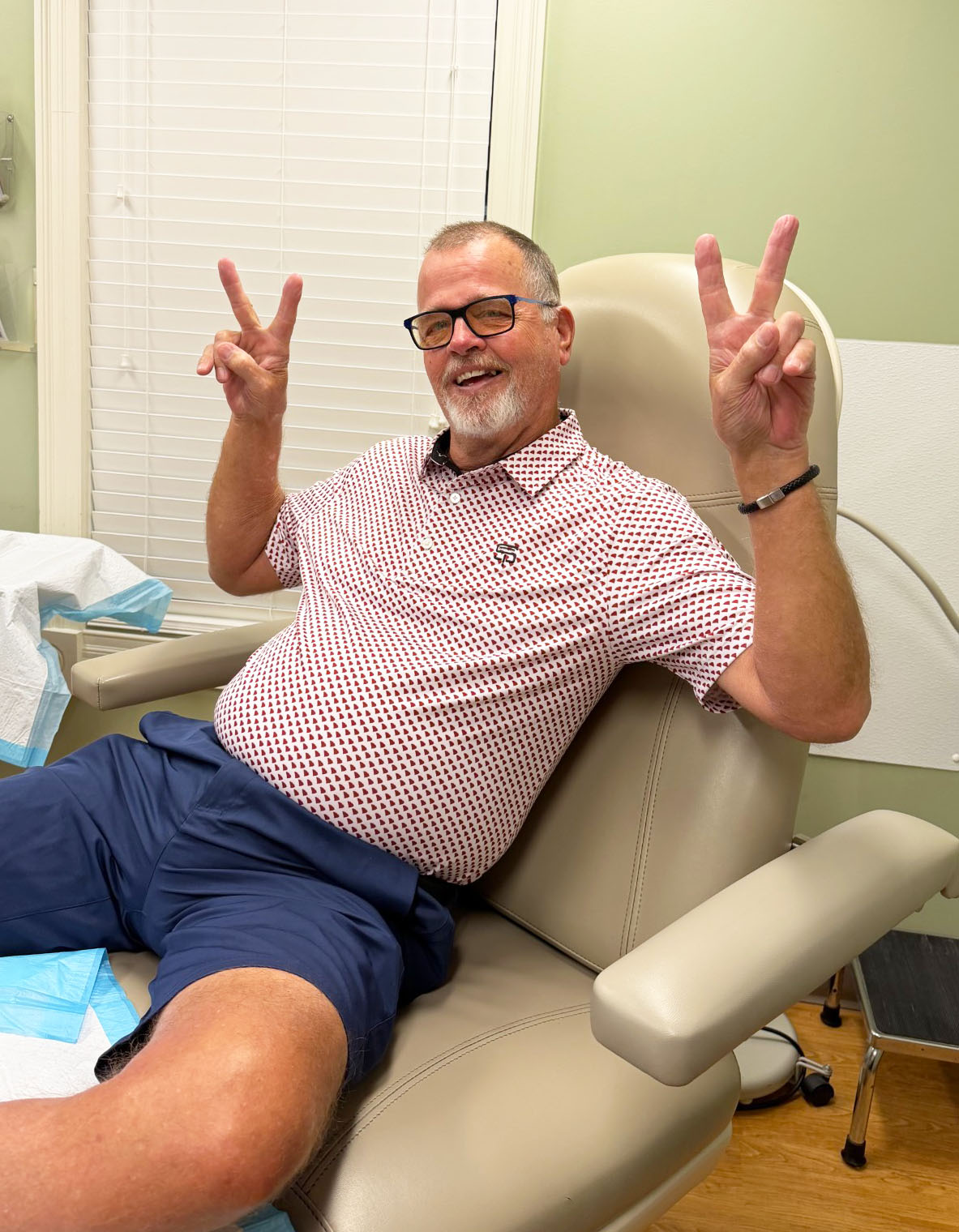 James wicker smiling holding up 2 fingers on each hand